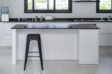 Modern black and white kitchen. Minimalist style kitchen with exterior windows.