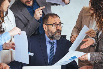 Shot of a mature businessman looking overwhelmed in a demanding work environment. Don't let the stress get the better of you. Shot of a mature businessman looking anxious