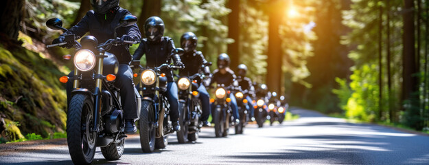 Group of motorcyclists on black motorcycles rides along a beautiful road through a mountain forest....