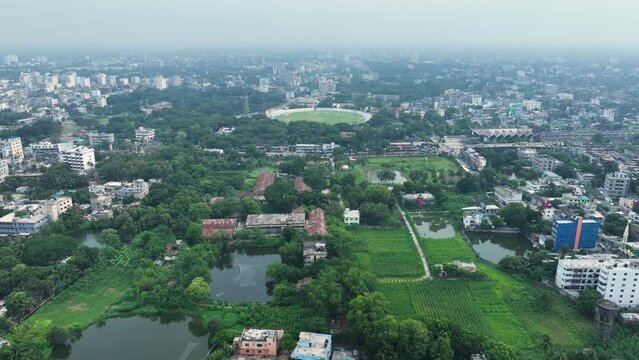 Aerial perspective of Rajshahi city in Bangladesh, nestled by the serene banks of the Padma River. Marvel at its vibrant urban landscape, rich heritage in this captivating drone footage. 4k