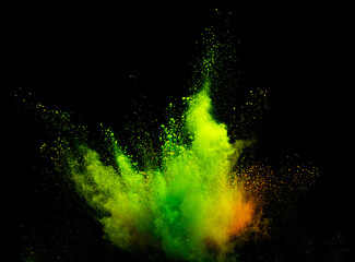Explosion of green powder dust on a black background