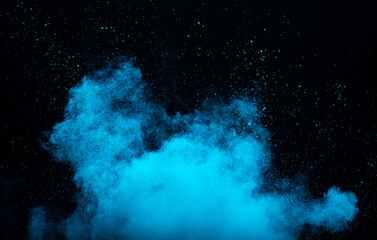 Blue powder dust smoke on black background