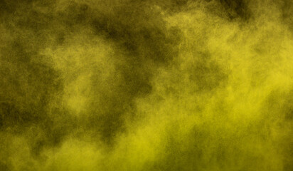 Fototapeta na wymiar Yellow powder dust smoke on black background