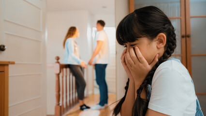 Stressed and unhappy young girl huddle in corner, cover her face while her parent arguing in...