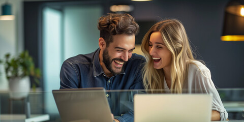 Joyful Coworkers Sharing a Moment at Work, Positive Collaboration Over Laptop, Friendly Office Atmosphere, Business Teamwork and Laughter, Modern Corporate Environment