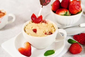 Strawberry shortcake mugcake - Valentines day microwave  cake in a mug for two, selective focus