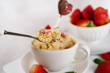 Strawberry shortcake mugcake - Valentines day microwave  cake in a mug for two, selective focus