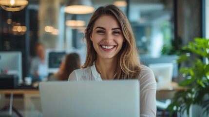 Beautiful cheerful young woman looking forward with laptop