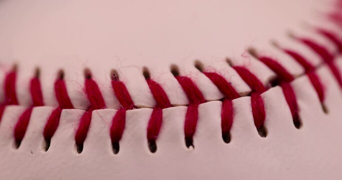 white baseball ball tied with red thread, a real round baseball ball close-up