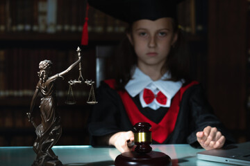Humorous portrait of serious female judge (lawyer) makes the decision. Selective focus on Femida...