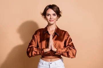 Fotobehang Photo of adorable cute girl wear brown blouse practicing yoga hands arms together isolated beige color background © deagreez