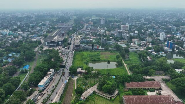 Aerial perspective of Rajshahi city in Bangladesh, nestled by the serene banks of the Padma River. Marvel at its vibrant urban landscape, rich heritage in this captivating drone footage. 4k
