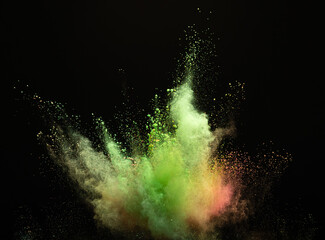 Explosion of yellow-green powder on a black background