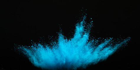 Explosion of blue powder, dusty smoke on black background