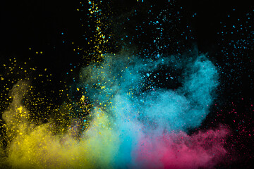 Explosion of colored multi-colored powder on a black background