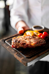 chef hold in his hands ready beef steak ribeye meat
