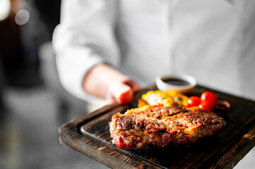 chef hold in his hands ready beef steak ribeye meat