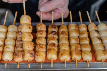 Mitarashi Dango are traditional Japanese rice dumplings on a bamboo skewer coated in a sweet soy glaze.