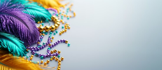 background for the greeting text with colored feathers and a scattering of beads