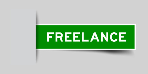 Green color square label sticker with word freelance that inserted in gray background