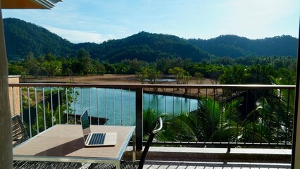 Laptop work remote remote office computer IT, travel with laptop office with lake mountains and palms remotely work education balcony with view Thailand praca zdalna biuro laptop komputer nomad