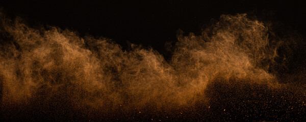 Orange powder dust smoke on black background