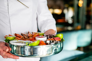 chef hold Set Mixed Seafood on plate