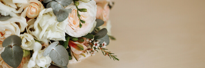 An elegant wedding bouquet featuring lush, white roses and vibrant greenery. Perfect for wedding...