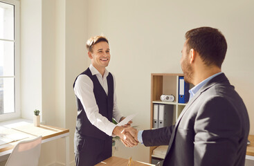 Business people handshake in greeting, showing agreement, contract and deal after negotiation. Male partners successful strategic discussion, understanding mutual benefit, lawyer office arrangement