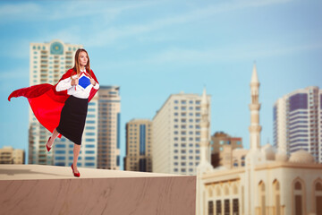 Superhero, motivation and power. Woman in red cape on high building in city
