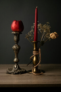 Still life art concept. Candlesticks and apple. Beautiful decoration.