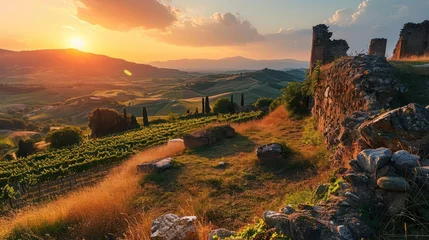 Zelfklevend Fotobehang grandeur of an Ancient countryside landscape at sunset, showcasing rolling hills, vineyards, and remnants of ancient architecture © Tina