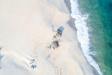 drone aerial top view of a beach at dawn