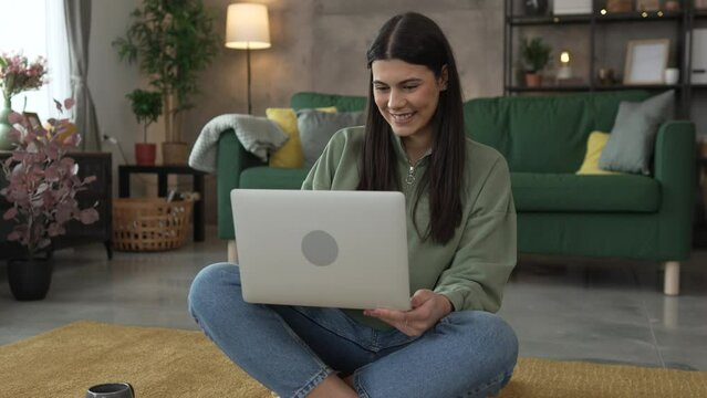 One young woman use laptop computer at home while sit comfortable