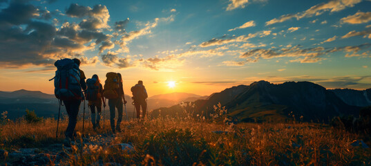 Group of sports tourists hiking in mountains during sunset with copy space