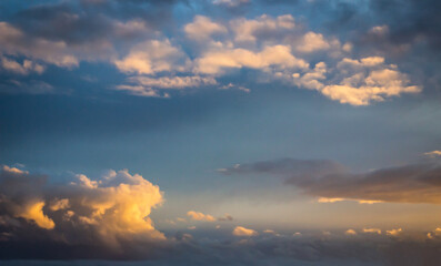 Naklejka na ściany i meble Blue sky clouds background. Beautiful landscape with clouds and orange sun on sky