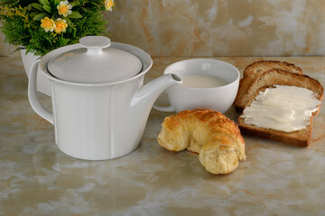 breakfast Coffee table, white porcelain teapot with milk jug and toast
