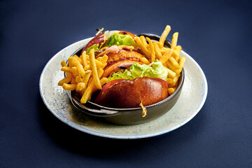 Burger with cheese and vegetables in a plate.