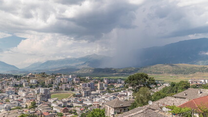 Fototapeta na wymiar Panorama showing Gjirokastra city from the viewpoint with many typical historic houses of Gjirokaster timelapse.