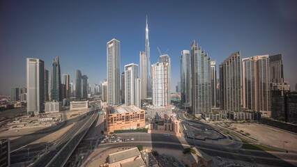 Aerial view of Dubai Downtown skyline with many towers all day timelapse.