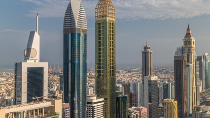 Obraz premium Skyline sunrise view of the high-rise buildings on Sheikh Zayed Road in Dubai aerial timelapse, UAE.