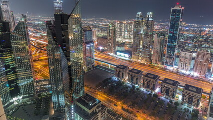 High-rise buildings on Sheikh Zayed Road in Dubai aerial day to night timelapse, UAE.