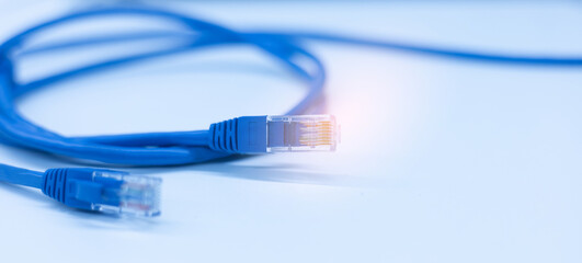 close up on RJ-45 connector wire on white table background to transfer packet and bandwidth and usage internet data to global network for internet technology transmission service concept	