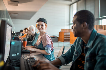 Diverse young students using computer in university lab