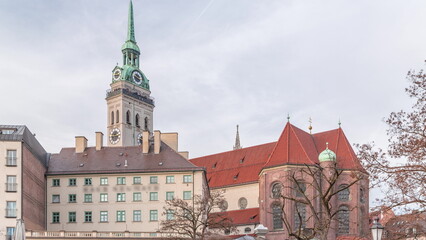 St. Peter's Church Peterskirche clock tower along Viktualienmarkt market street timelapse in Munich, Bavaria, Germany.
