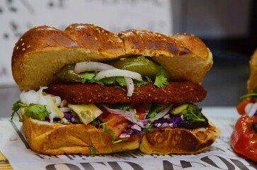 Chicken schnitzel in the Challah. Israeli street food. Challah sandwich - sabich. Eggplant, grilled...