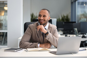 Naklejka premium Happy man working at table in office. Lawyer, businessman, accountant or manager