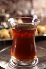 Traditional Turkish tea in glass on table, closeup