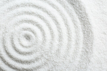 Fototapeta na wymiar Zen rock garden. Circle pattern on white sand, top view