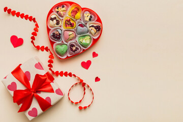 Valentine day composition: sweet candy, with gift boxes with bow and red felt hearts, photo template, background. Top View with copy space